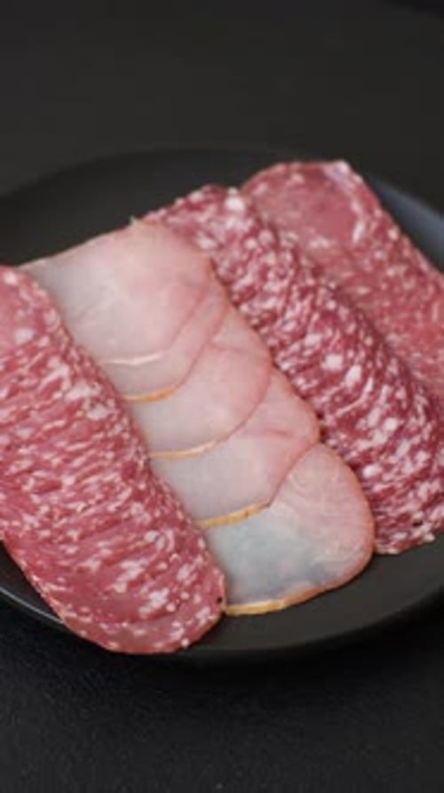 Salami and Ham Slices on Dark Plate