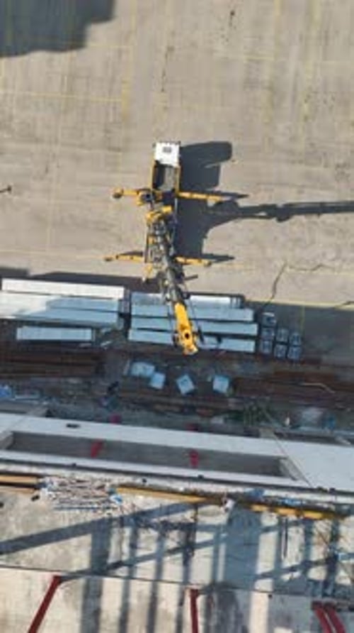 Vertical Video Aerial View SkyHigh Construction Site Roof and Facade Work