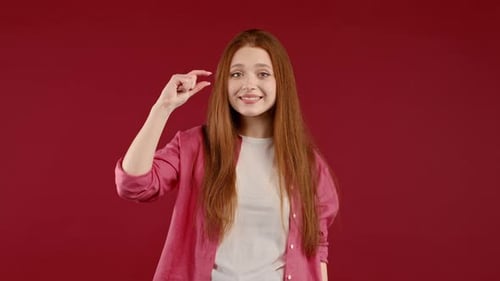 Woman Uses Hand Gestures to Compare Sizes