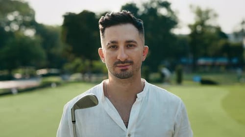 Portrait of Bearded Man with Golf Club Smiling to Camera