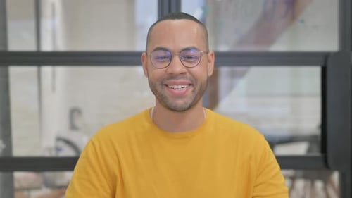 Young Adult Talking and Waving to Camera