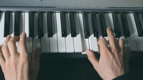 Hands of Male Musician Playing at Synthesizer Mens Arms Plays Solo of Music or New Melody Close Up