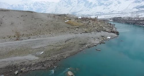 Aerial view of snowy mountains and barren land, Pakistan.