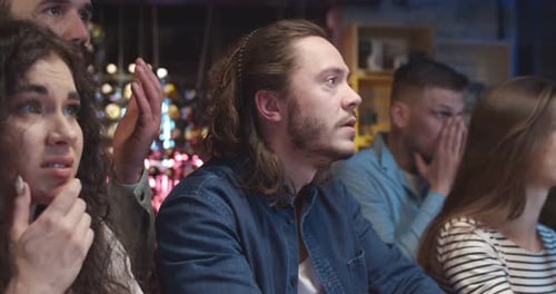 Excited Friends Watching Sports at Bar Together