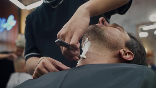 Man Getting a Straight Razor Shave at Barbershop