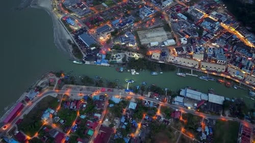 Nighttime aerial shot reveals coastal town's vibrant lights