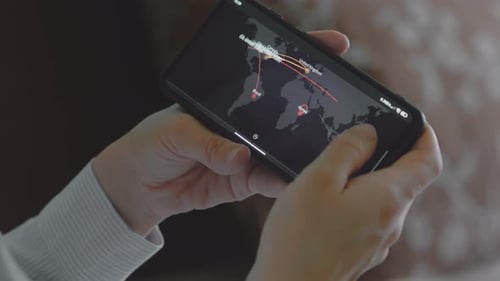 Woman Navigating a World Map on a Smartphone