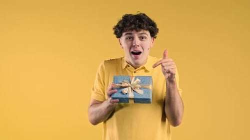 Excited Man Hold Gift Box with Bow