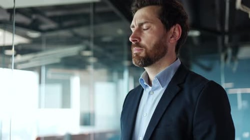 Upset Caucasian Male Worker Feeling Sad While Posing in Office Interior