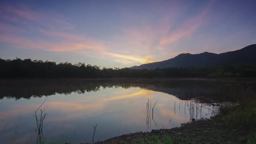 Morning view of the misty reservoir at the top of the water, surrounded by mountains. beautiful sky.