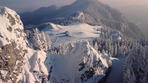 Experience the enchantment of a winter cabin atop a snow-covered mountain, a captivating hideaway am