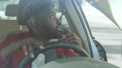 Man Talking on Phone in a Vehicle