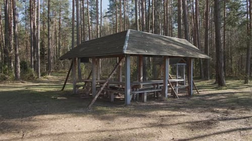 A Beautifully Crafted Wooden Gazebo Situated Within A Peaceful And Serene Forest Environment