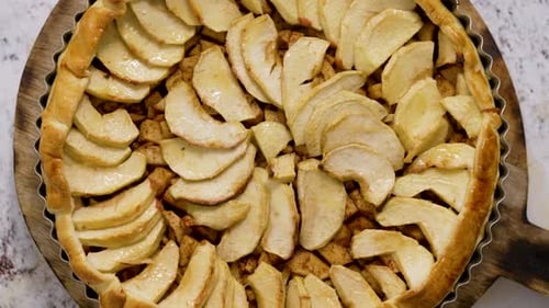 Homemade Delicious Apple Cake with Raisins and Cinnamon Over Stone Background Top View