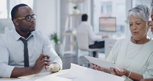 Colleagues Collaborating in Modern Office with Tablet