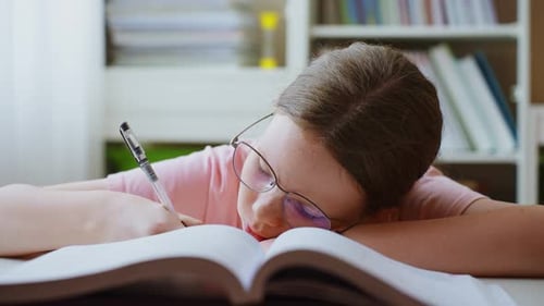 Tired Student Napping on Book While Studying