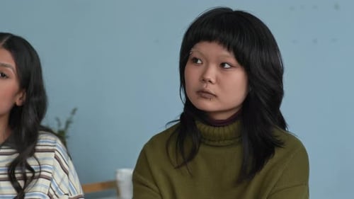 Young Adult with Black Hair Listening Indoors