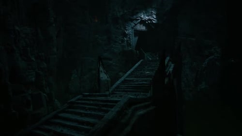 Dark Staircase Leading to a Mysterious Cave Entrance at Night