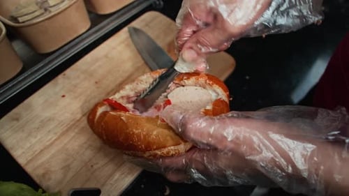 Sandwich Being Assembled with Meat and Toppings