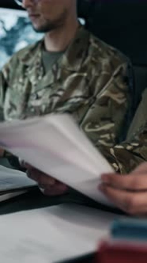 Vertical of Military Workers Analyzing Data in Command Hub