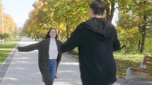 Fall Romance Couple Smiling and Embracing in Scenic Park