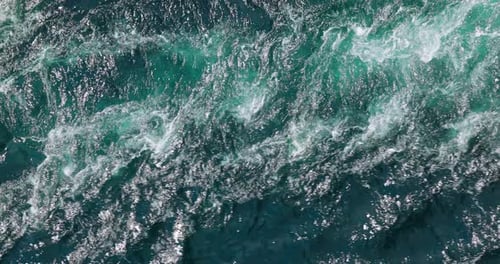Blue waves of water of the river and the sea meet each other during high tide and low tide.