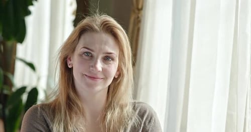 Blonde Woman Smiling and Looking Forward