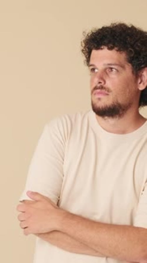 Man With Curly Hair Looking Thoughtful