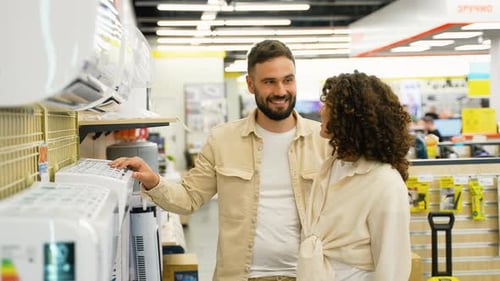 Couple Choosing Air Conditioner in Electronics Store on Black Friday