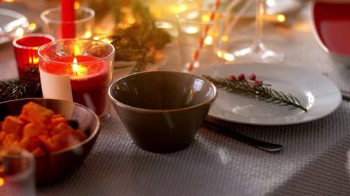 Holiday Table Setting with Candles and Winter Decorations