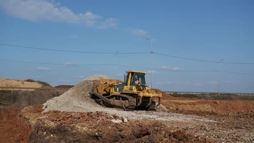 Bulldozer on Dirt Pile at Construction Site