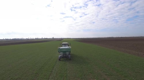 Tractor In Wheat Field At Sunrise