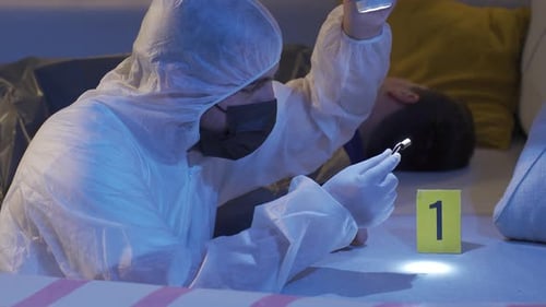 Forensic Examiner Investigating Evidence on a Couch