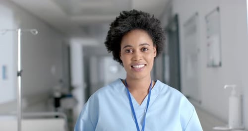 African American nurse smiles brightly in a hospital setting