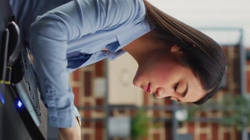 Vertical Video Asian Female Engineer Using Touchscreen Display to Create Game Interface