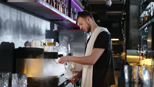 Young Adult Making Steaming Cocktail in Urban Bar