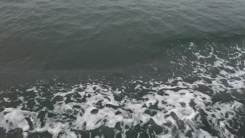 Foamy Waves Splash On The Side Of A Traveling Ferry. - Tracking Shot