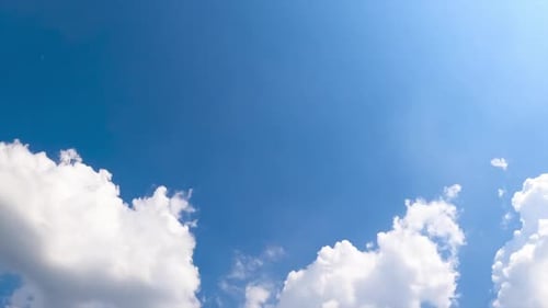 Clouds Drifting in a Bright Blue Sky