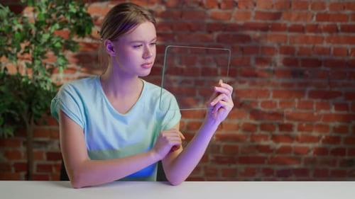 Female Holding Innovative Futuristic Tablet with Transparent Glass Screen Swiping and Watching Media