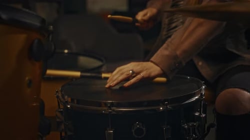Drummer Plays Drumset in Studio at Night