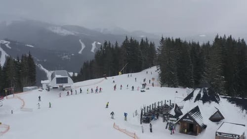 Skiers and snowboarders enjoy winter activities at a snowy mountain resort