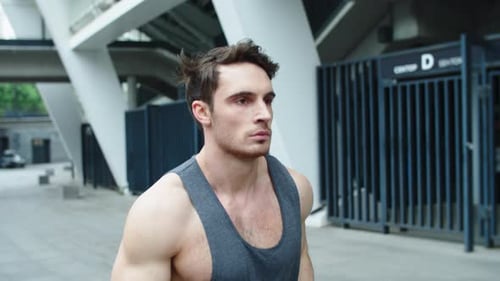 Closeup Sporty Man Jogging On Urban Street In Slow Motion. Male Runner Training Run Exercise On C...