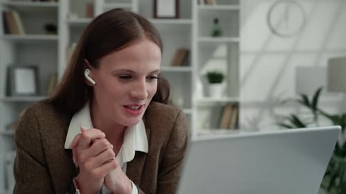 Young Woman Attends Virtual Meeting in Office Setting