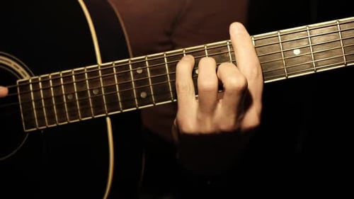 Guitar Player Strumming Chords on Acoustic Guitar