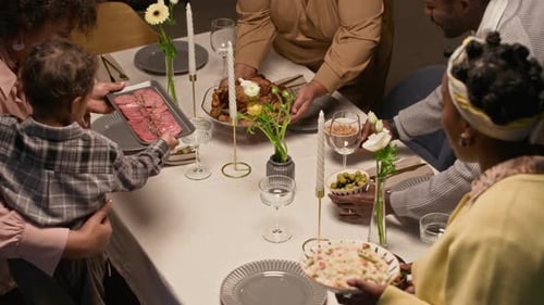 Diverse Family Preparing Food for Dinner at Table