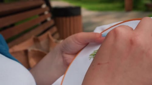 Close Up of Skilled Person Embroidering Pattern with Needle and Thread