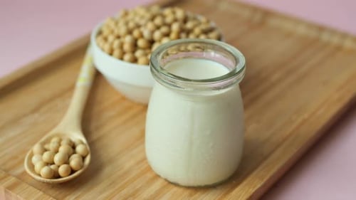 Soy Milk Pouring in a Glass Jar