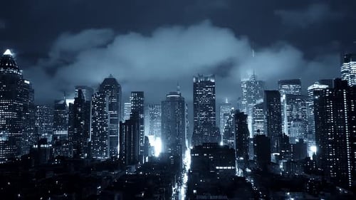 Cityscape Showcased at Night Revealing a Stunning Skyline Under Dramatic Clouds and Lights