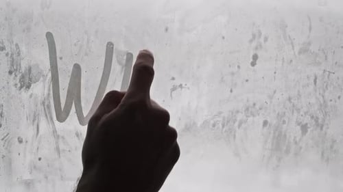 Hand Writes Winter on Fogged Glass