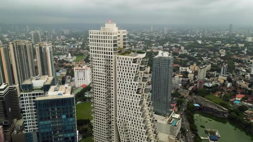 Drone View Captures Urban Landscape Modern Skyscrapers with Green Rooftop Gardens Above Bustling